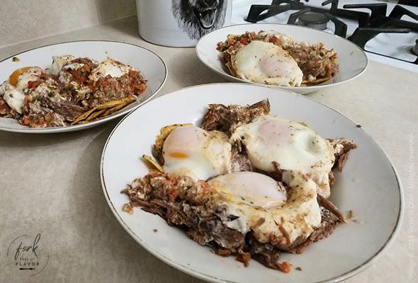 Chilaquiles & Eggs topping a bowl of crunchy tortialla chips.