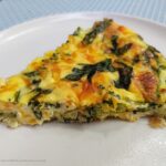 Broccoli, Ham and Cheese Quiche ready to eat on a plate