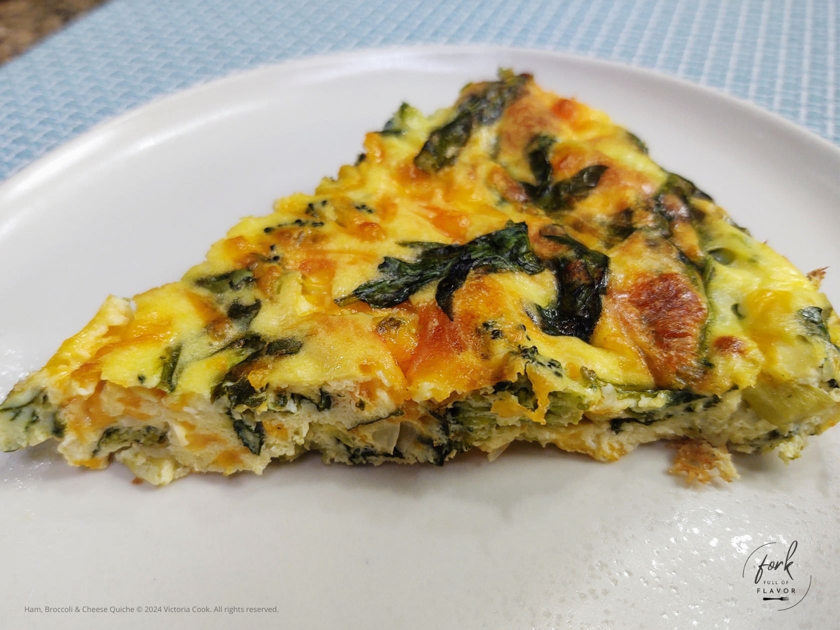 Broccoli, Ham and Cheese Quiche ready to eat on a plate