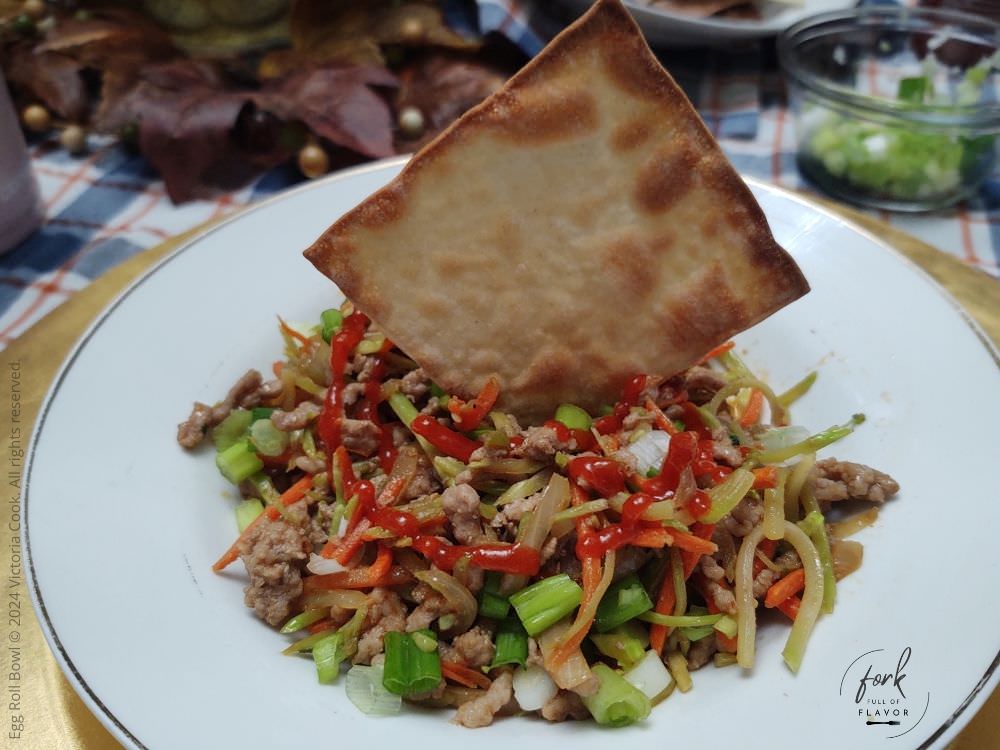 Egg roll bowl made with ground pork plated and served with an air-fried wonton