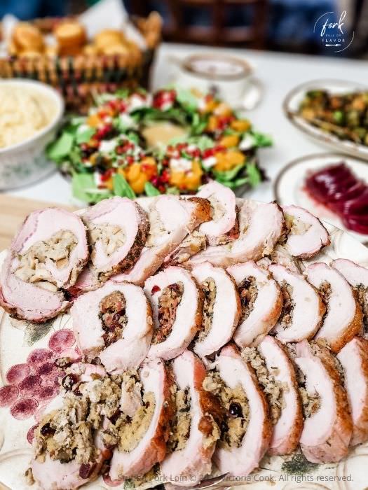 Stuffed Pork Loin - plated Three stuffed pork loins each with a different stuffing sliced and plated for serving.